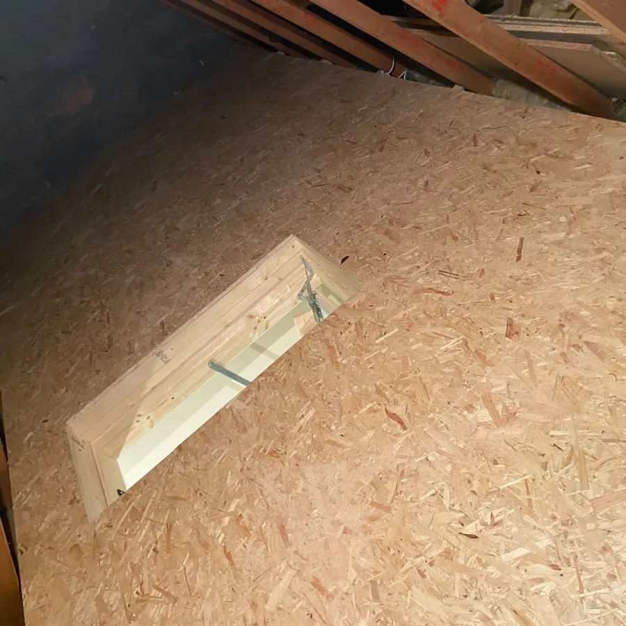 Close-up of the boarded deck edge where it meets the hatch opening