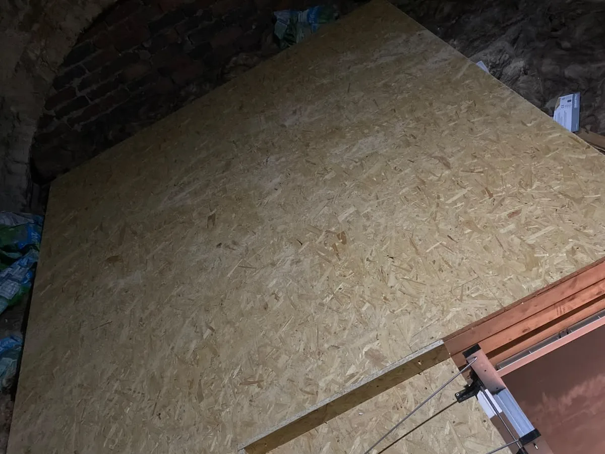 Loft boarding laid over a brick arch in an older property