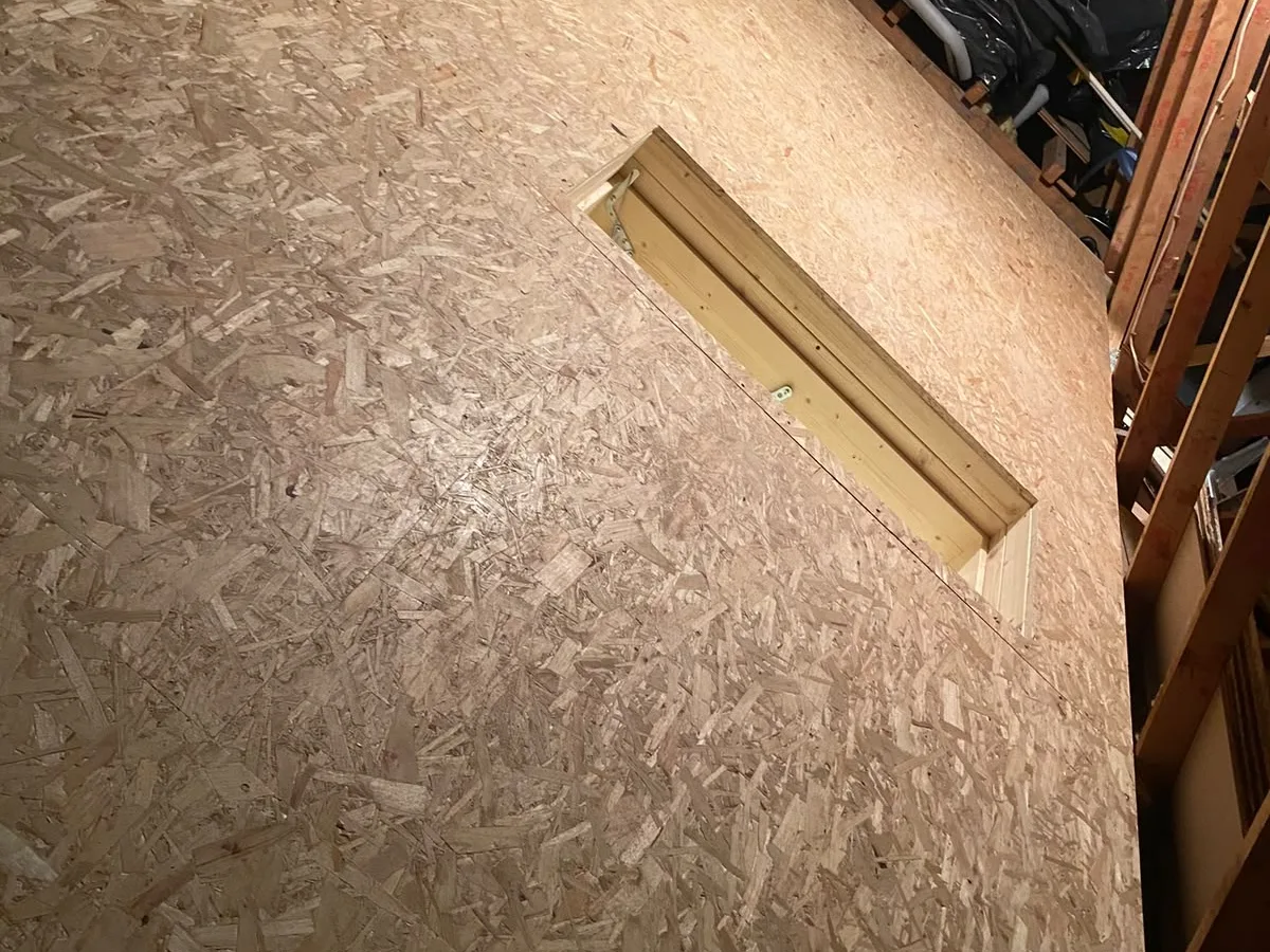 Boarded loft deck with the hatch opening framed and trimmed
