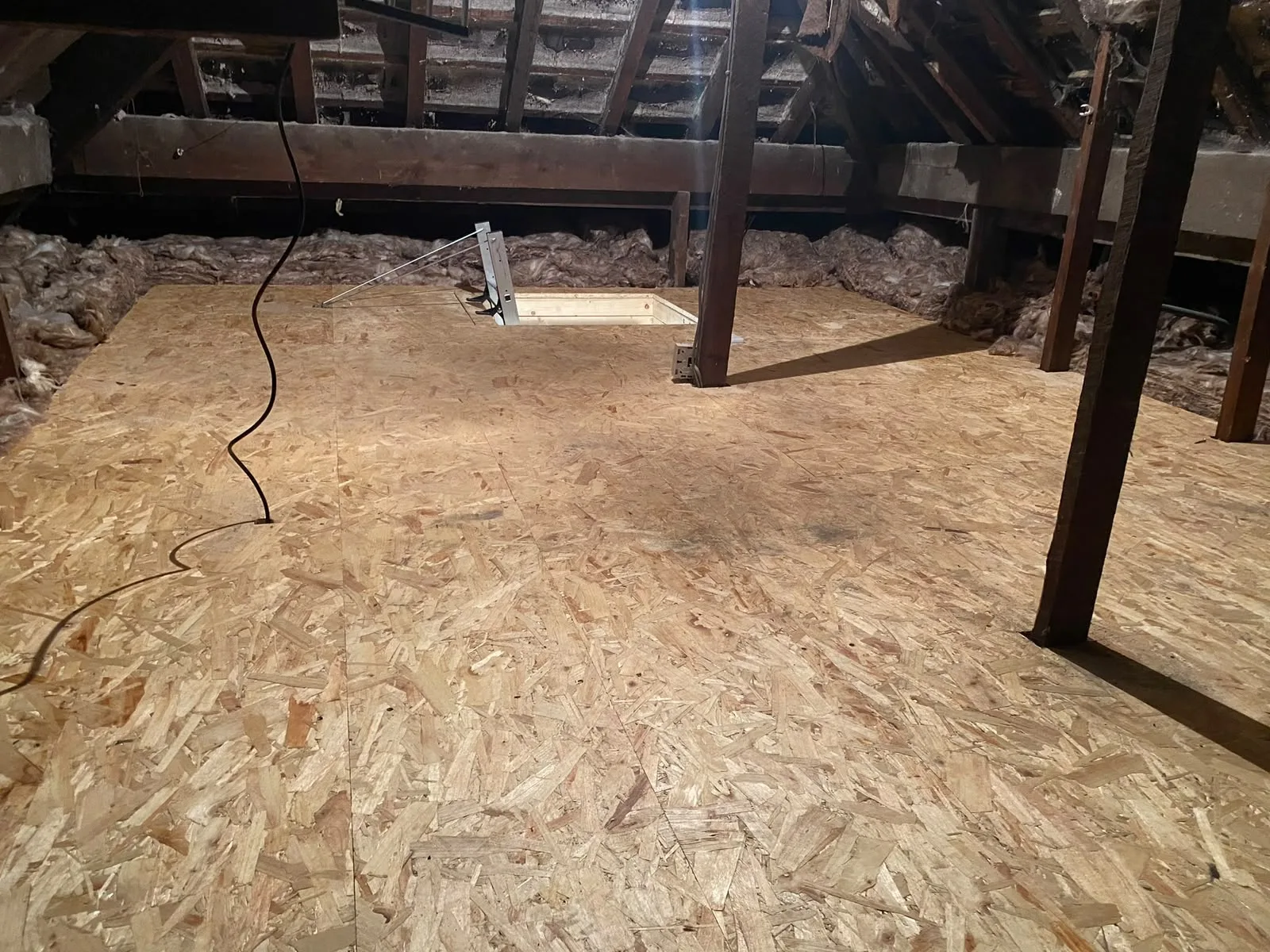 Finished loft boarding with a new hatch opening set into the deck
