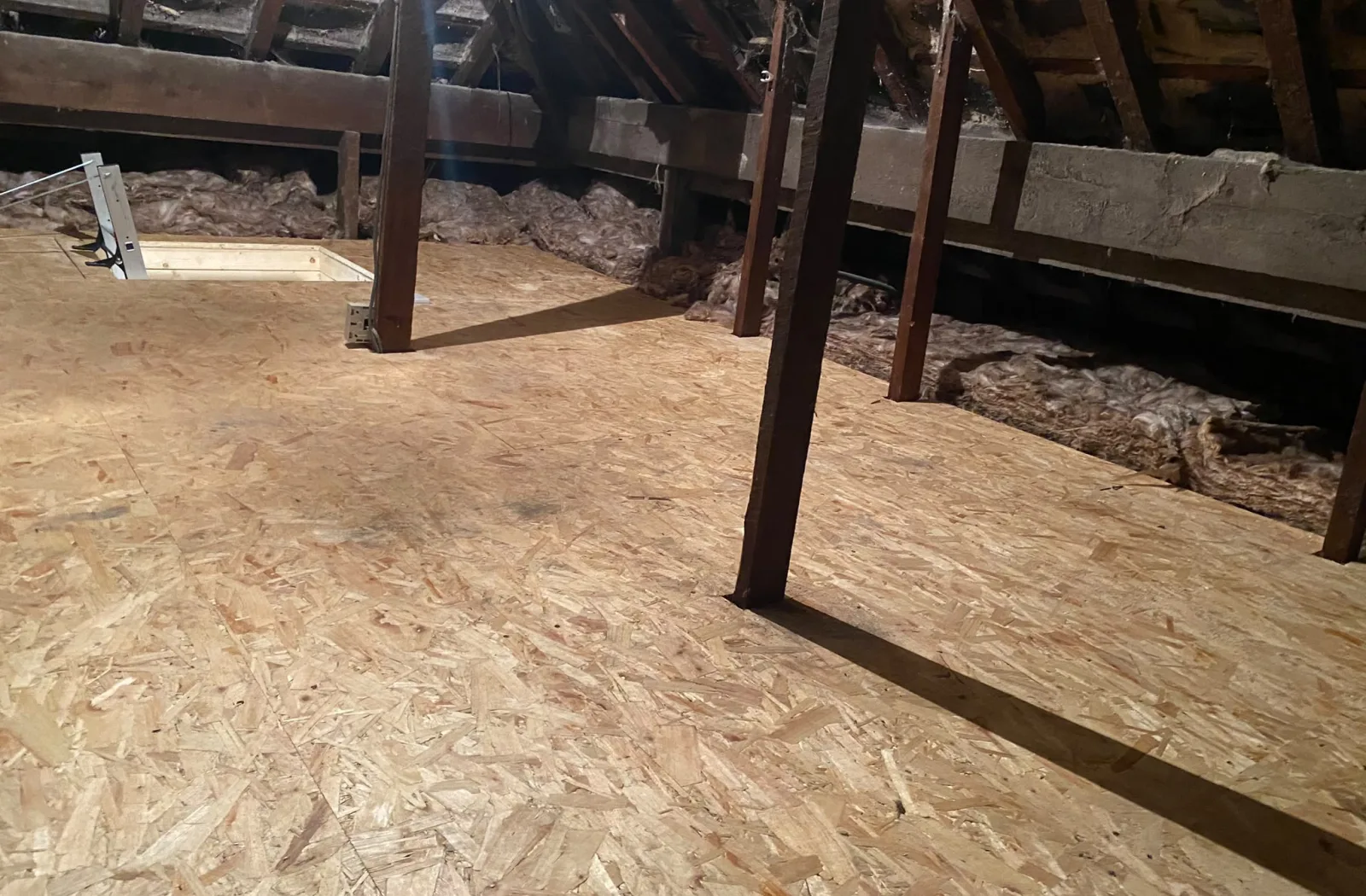 Wide view of a fully boarded loft, deck running the length of the roof space