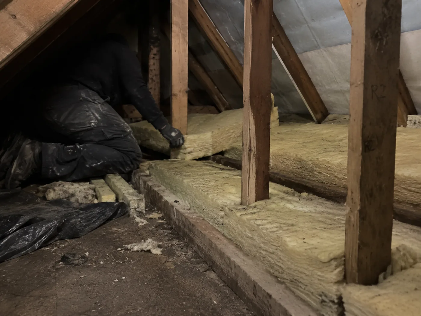Second layer of mineral wool going across the joists mid-lay