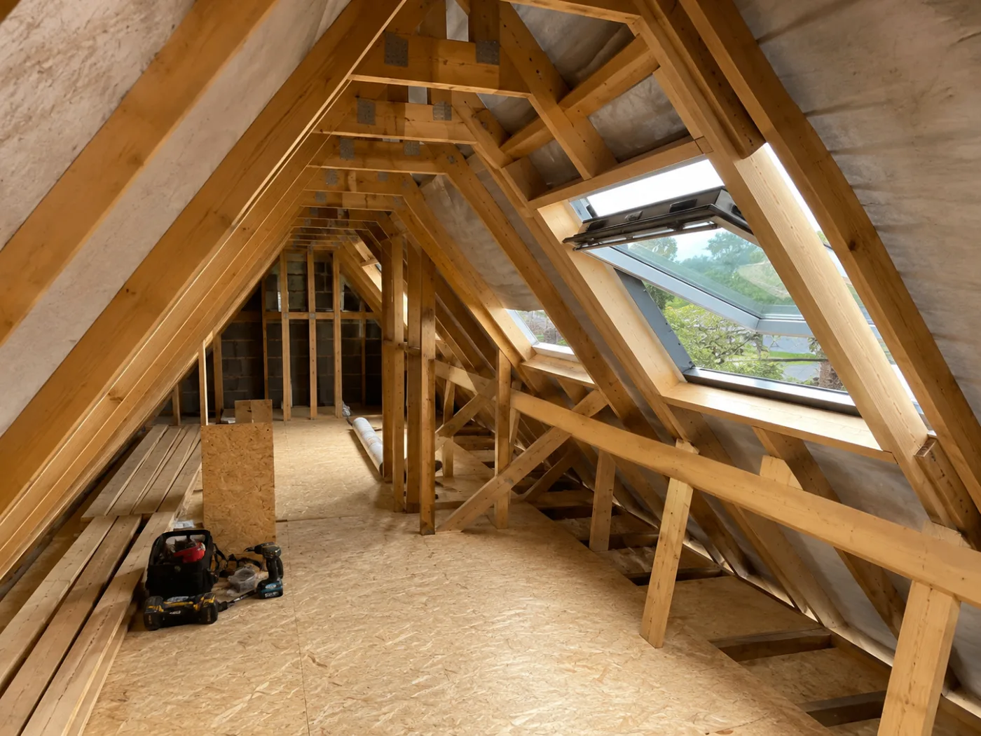 Wide view of a loft roof space with roof windows along the slope