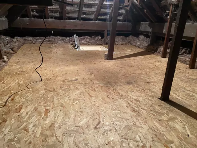 Wide boarded loft floor with the ladder hatch at the back