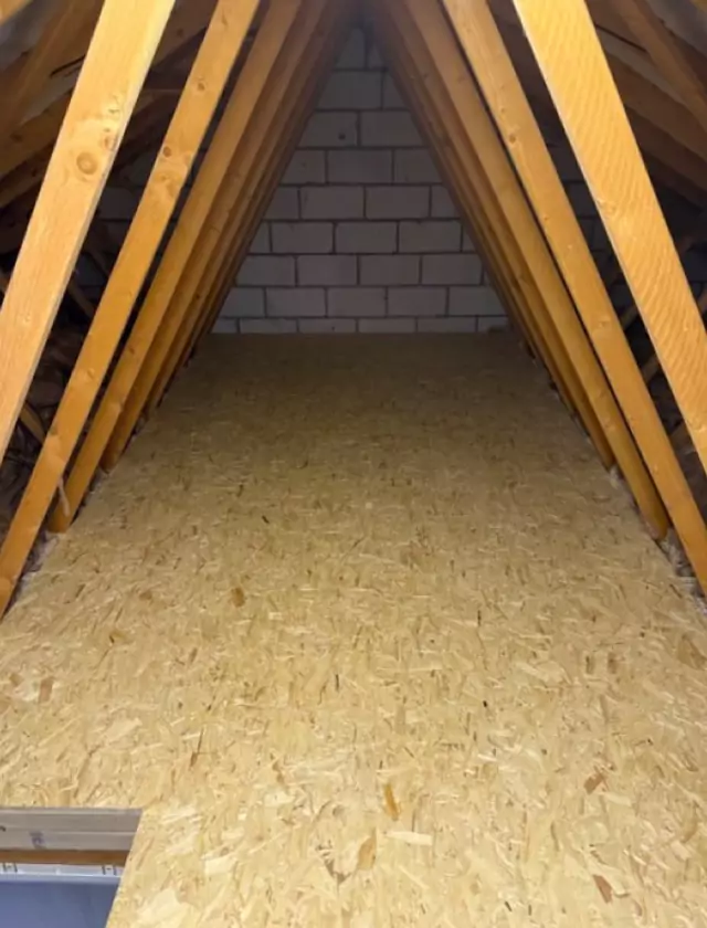 Boarded floor between trusses up to a blockwork gable