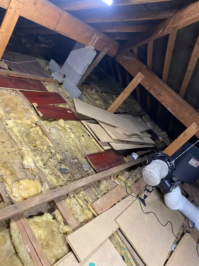 Before: old boards, loose insulation and ducting across the joists