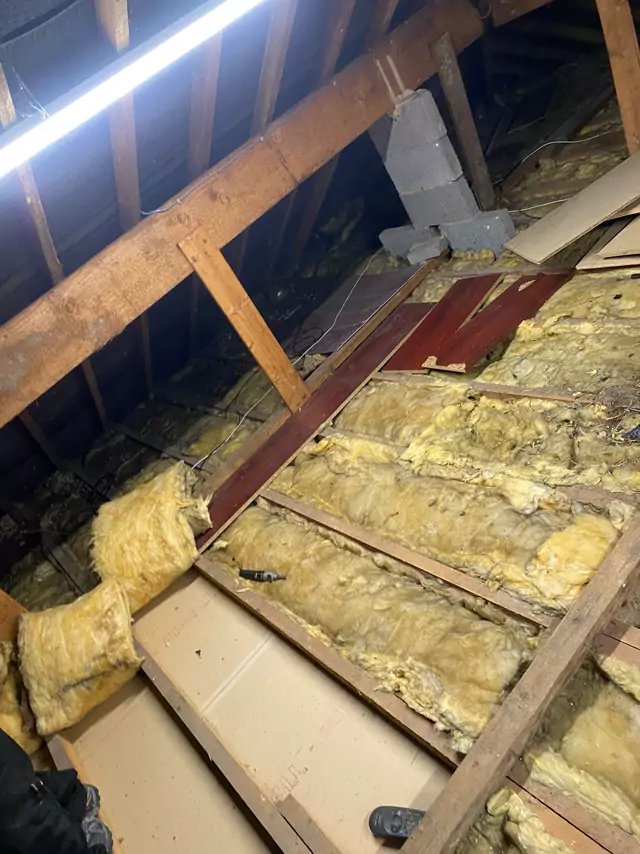 Before: patchy old boarding and insulation between the joists
