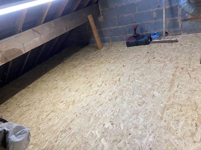 Boarded loft against a blockwork gable wall