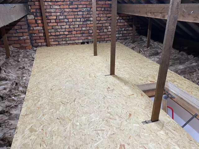 Boarded storage deck with the loft ladder hatch and timber props