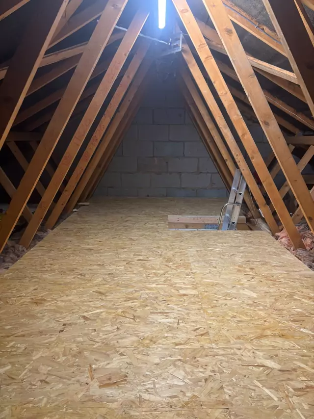 Boarded loft with an LED batten along the ridge