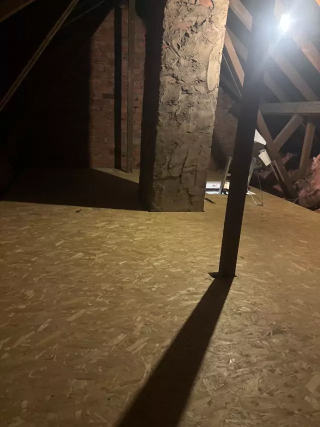 Boarded loft round a chimney stack in an older roof
