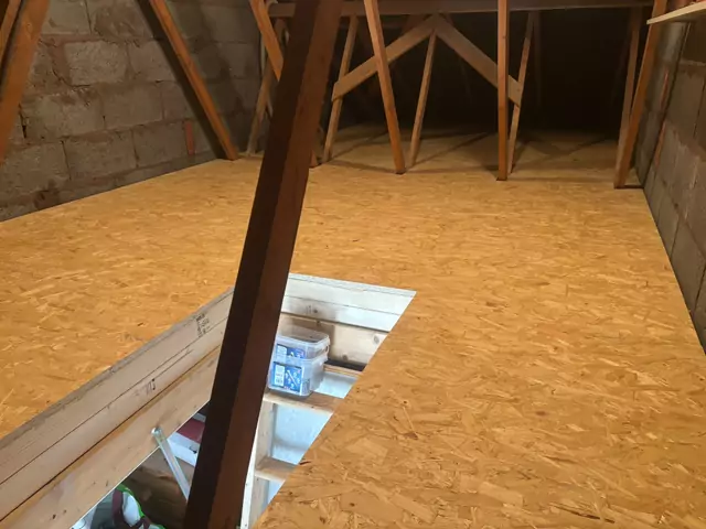 Hatch opening framed into the boarding beside a timber prop