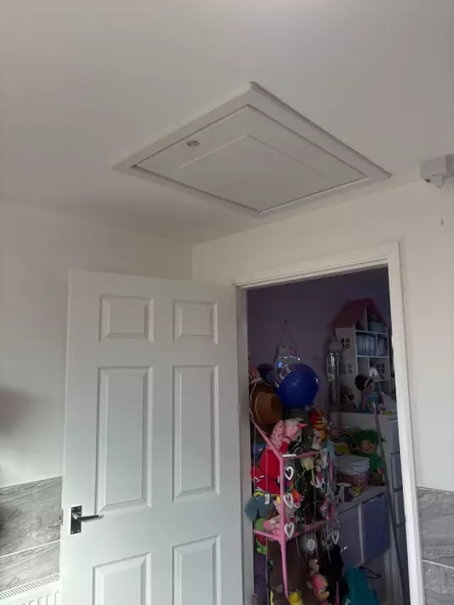 The same hatch closed, sitting flush in the ceiling