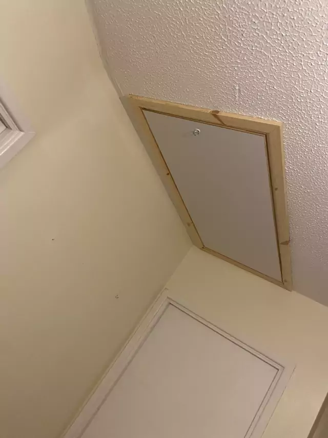 Timber-trimmed hatch in a sloping ceiling