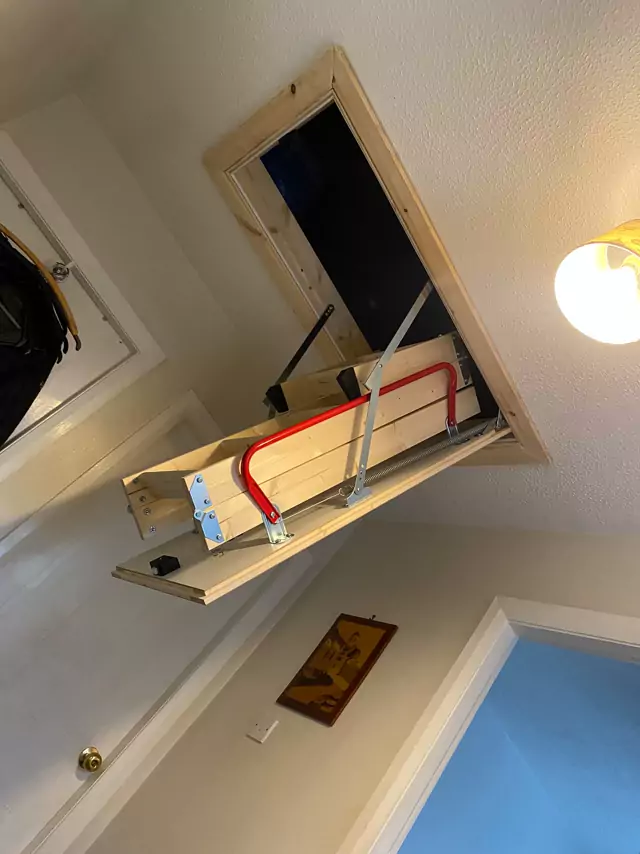 Timber loft ladder folded up into its hatch
