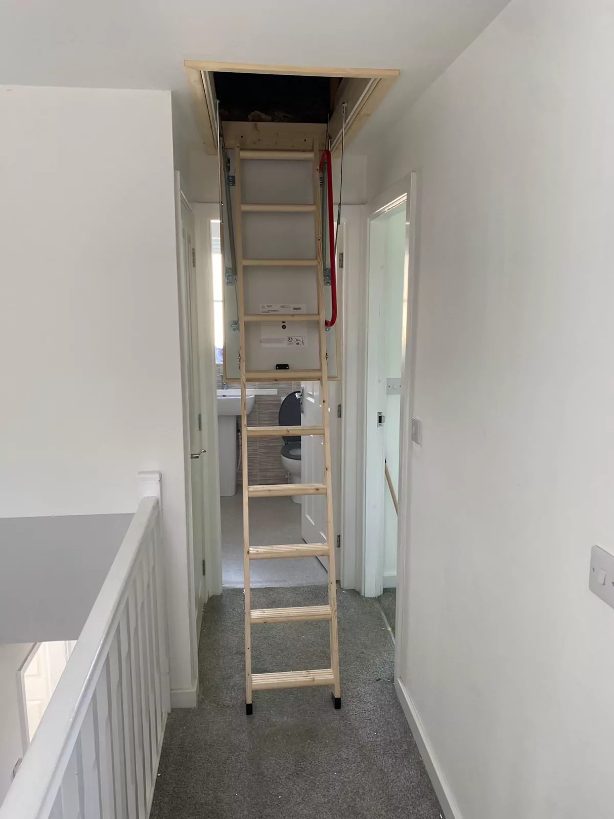 Timber concertina loft ladder down onto a landing
