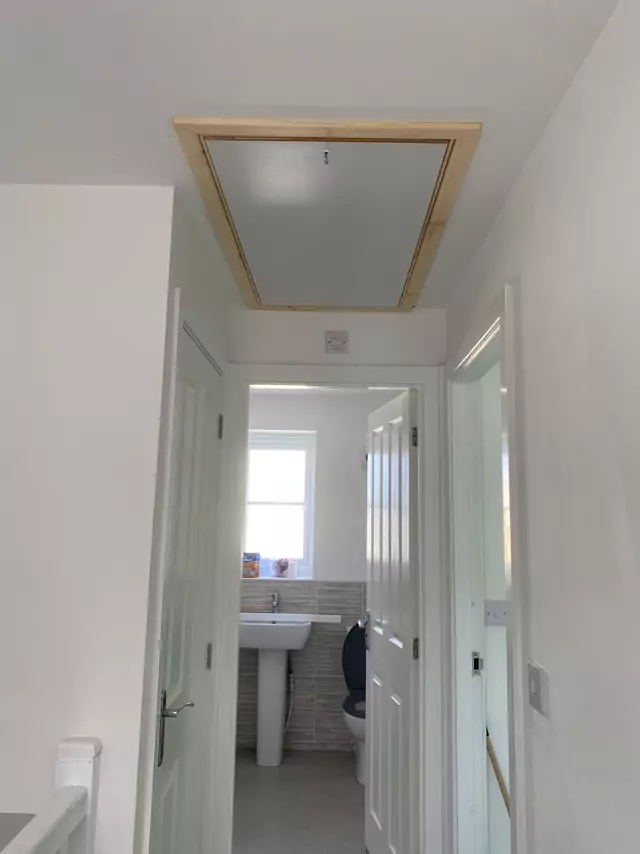 New hatch with timber trim in a landing ceiling
