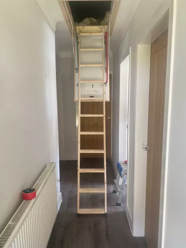 Timber loft ladder down into a hallway