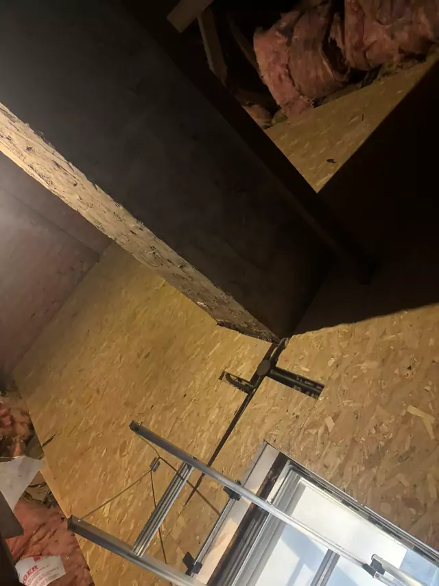 Aluminium loft ladder leading up into a boarded loft