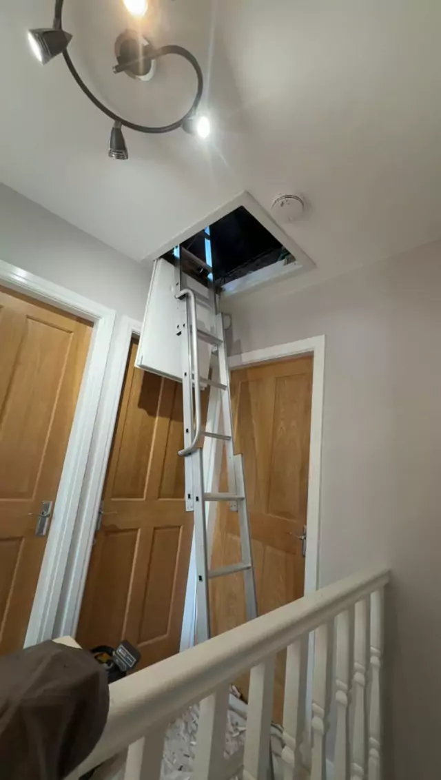Aluminium loft ladder up through a landing hatch